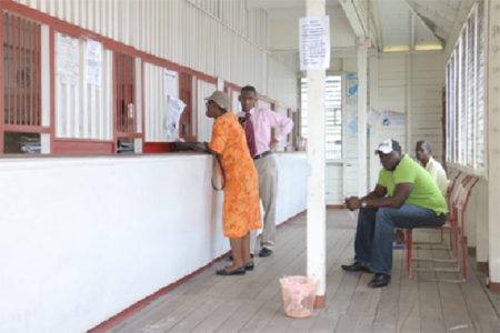 Customers conducting business at the Kitty Post Office yesterday.
