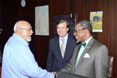 This GINA photo shows President Donald Ramotar (left) receiving Dr Ivelaw Griffith. At centre is US Ambassador Brent Hardt.