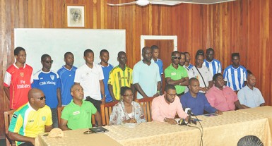 UDFA President Sharma Solomon addressing the media gathering while members of the UDFA executives (sitting) inclusive of GFF Vice President Collie Hercules (second left) and the representatives of the 14 clubs look on. Netrockers FC were not represented at the briefing.