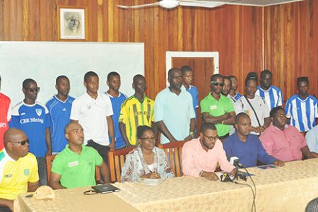 UDFA President Sharma Solomon addressing the media gathering while members of the UDFA executives (sitting) inclusive of GFF Vice President Collie Hercules (second left) and the representatives of the 14 clubs look on. Netrockers FC were not represented at the briefing.