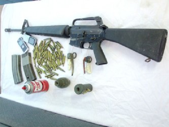 The rifle and the magazines along with the grenades that were recovered yesterday by police from the teens. (Guyana Police Force photo)