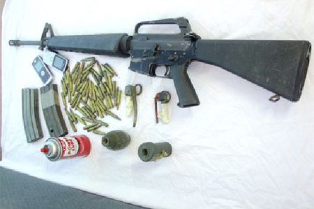 The rifle and the magazines along with the grenades that were recovered yesterday by police from the teens. (Guyana Police Force photo)