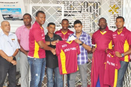 National skipper Christopher Barnwell receives a club T-shirt from the sponsors, while DCC President Alfred Mentore (second from left) and other players look on.
