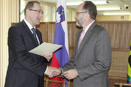 Newly-appointed Slovenian Ambassador to the Caricom His Excellency Dr. Bozo Cerar hands over his credentials to Caricom Secretary General Ambassador Irwin LaRocque in a ceremony at the Caricom Secretariat yesterday. (Caricom Secretariat photo)