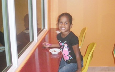 A young girl enjoys her yogurt yesterday at the official opening of Yog Yog’s Frozen Yogurt 