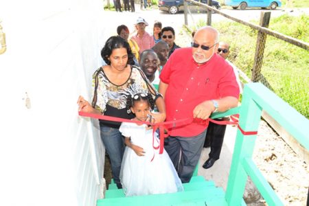 President Donald Ramotar (right) during the cutting of the ribbon to launch one of the expanded core homes at La Parfaite Harmonie (GINA photo)