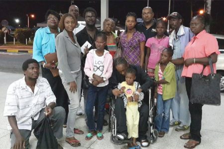 Colwyn Harding (in wheelchair) poses with family, friends and supporters shortly before he checked in at the Cheddi Jagan International Airport. He and his mother, Sharon (right) later left for Jamaica where he is expected to received additional medical attention. 