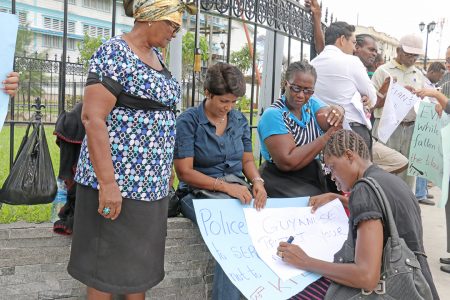 Some of the protesters near Parliament today condemning the police treatment of Colwyn Harding.  Harding has alleged that he was sodomized by a policeman with a baton and beaten among other indignities. He is now hospitalized at the Georgetown Hospital.