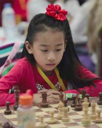 Canada’s seven year-old chess and music prodigy, Harmony Zhu, (in photo above), in unwavering concentration at the chessboard during her final decisive game at the recent World Youth Chess Championships at Al Ain, in the United Arab Emirates. The remarkably talented Zhu captured the coveted gold medal for the Girls-under-8 category of the championships. She even elicited a comment from former world champion Garry Kasparov, who said: “Did you see the Canadian girl? Very impressive!”  In addition to playing a sharp brand of chess, Harmony is equally talented on the piano, playing Mozart, Beethoven, Bach, Chopin, etc, with ease and courage. She performed at the Carnegie Hall in New York twice in 2013. Harmony is a student at the Royal Conservatory of Music in Toronto.  Her brilliant performances in both disciplines will, perhaps, promote the name of her nation at the same time. 