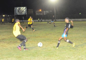 Mahaica Determinators Shameer Nazeer (sixth from left) in the process of challenging Orin Yarde of Santos for possession of the ball during Sunday night’s GFF Premier League match. (Orlando Charles photo) 