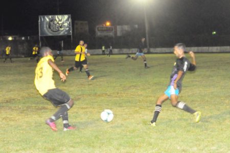 Mahaica Determinators Shameer Nazeer (sixth from left) in the process of challenging Orin Yarde of Santos for possession of the ball during Sunday night’s GFF Premier League match. (Orlando Charles photo)