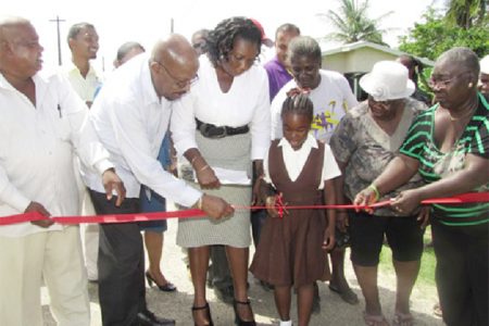 Minister of Local Government and Regional Development Norman Whittaker (second from left), along with residents commissions the Calcutta School Street (GINA photo)