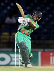 Guyana’s Shivnarine Chanderpaul strikes one of his three sixes in his topscore of 65 albeit in a losing cause yesterday as Jamaica won the final preliminary game by the narrow margin of 10 runs. (WICB media photo)