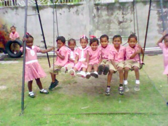 Students from Pitt's Play School on the swing