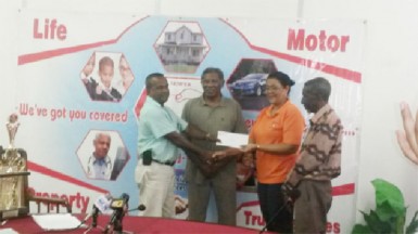 Hand-in-Hand’s Human Resources Administrative Manager Zaida Joaquin, right, hands over the sponsorship cheque to Rabindranauth Saywack, assistant treasurer of the West Berbice Cricket Association.