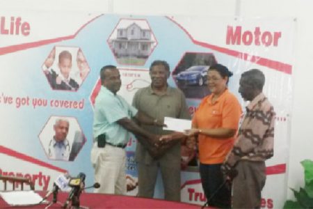 Hand-in-Hand’s Human Resources Administrative Manager Zaida Joaquin, right, hands over the sponsorship cheque to Rabindranauth Saywack, assistant treasurer of the West Berbice Cricket Association.