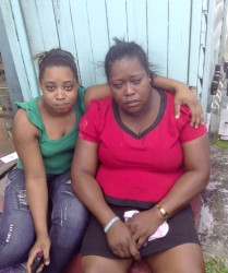 Carla Archer (left), Vanessa Higgins’s 18-year-old daughter, comforts her mother after yesterday’s fire. 