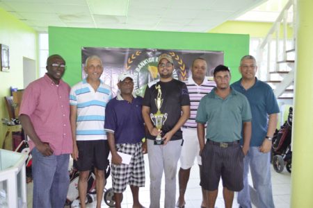 George Bulkan (with trophy) and members of the successful Underdogs team pose with Banks DIH Sales and Marketing Executive Carlton Joao and Citizens Bank Senior Credit and Marketing Manager Lindel Harlequin.