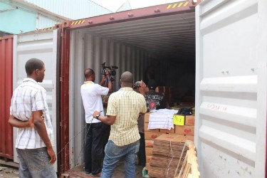Representatives of the Guyana Revenue Authority’s Goods Examination Unit and Public Relations witnessing the inspection of commercial goods at the Demerara Shipping Company Ltd (GRA photo)