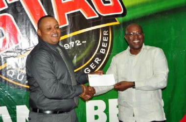 Marketing Director of Ansa McAL,Troy Codogan (left) presenting the sponsorship cheque to president of the GBA, Steve Ninvalle. (Orlando Charles photo) 