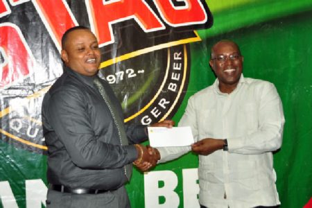 Marketing Director of Ansa McAL,Troy Codogan (left) presenting the sponsorship cheque to president of the GBA, Steve Ninvalle. (Orlando Charles photo)
