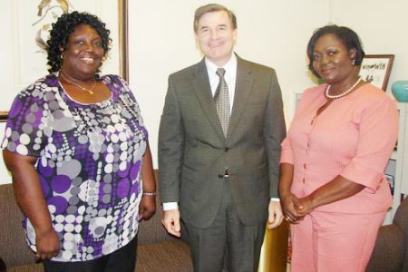 Founders of WEN Guyana Barbara Dublin-Peterkin and Lucia Desir-John flank US Ambassador D Brent Hardt.