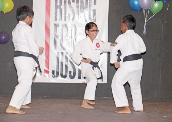 A young student of the Guyana Karate College goes on the offence against her classmates during a self-defence demonstration at yesterday’s One Billion Rising event. (Arian Browne photo) 
