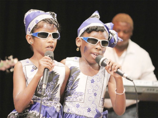 We do calypso too: Mekyla Belgrave and Angelica Bassoo of the Resource Unit for the Blind and Visually Impaired performing `I can’ in the calypso segment of the children’s Mashramani contest finals on Thursday at the National Cultural Centre. (Arian Browne photo) 