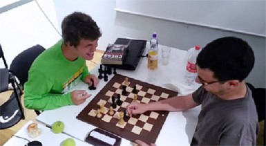 23-year-old world chess champion Magnus Carlsen tests the skill of Laurent Fressinet with a bullet game. Fressinet is ranked number three in France, and served as Carlsen’s assistant during the Anand match. The game was played in August 2013, and was posted on Carlsen’s Facebook page with the following comment: ‘’Winning a blitz game against my good friend at Kragero (Norway). He’s too weak and too slow, but a very nice guy.’’  The world number one got into trouble against his friend, but pulled off an incredible mate in the middle of the board. The Carlsen strategy works, apparently: Give your opponent ample opportunity to make mistakes. Carlsen (left) after executing checkmate against Fressinet.