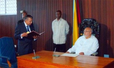 Justice Rabi Sukul taking the oath of office before President Donald Ramotar last July (Stabroek News file photo)