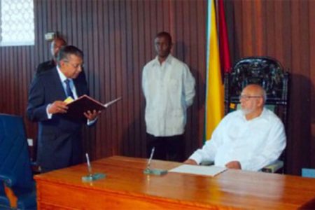 Justice Rabi Sukul taking the oath of office before President Donald Ramotar last July (Stabroek News file photo)