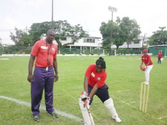 Coach Quacen Nedd teaching Sanyu Williams of Queen’s College the forward defence.