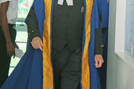 Justice David Hayton striding into the Guyana International Conference Centre, Liliendaal, East Coast Demerara yesterday morning for the inaugural sitting of the CCJ here. (Photo by Arian Browne)