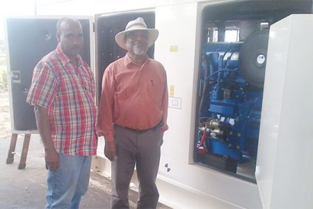 Prime Minister Samuel Hinds and Chairman of LMPCI John Macedo standing in front of one of the new generators which arrived in Lethem on Friday.
