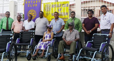 Robby Saywack (third left) and Rajendra Rajkumar (fourth left) and members of the Board of Directors of the RCNA posing with the two recipients  