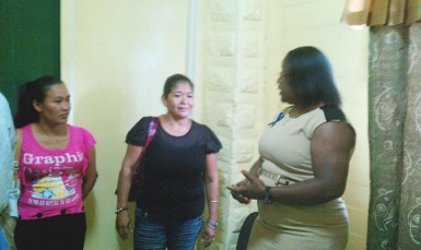 From left are Fatima Martin’s sister Charmain Martin, her aunt Gloria Johnson talking to Simona Broomes yesterday. 