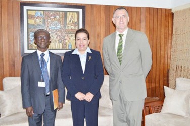In this GINA photo Dr William Adu-Krow (left) stands with Minister of Foreign Affairs, Carolyn Rodrigues-Birkett and PAHO Senior Advisor, Adrianus Vlugman. 