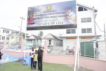 Terriann Wright (centre), one of the beneficiaries of the Gift of Life programme, stands with her mother Jillian Henry (right) and sister Marissa Wright (left) in front of the recently unveiled Gift of Life billboard. 