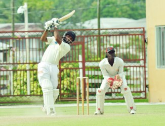 Assad Fudadin goes over extra cover during his unbeaten 117 while the national team’s skipper Leon Johnson punches one off the back-foot in his 46  