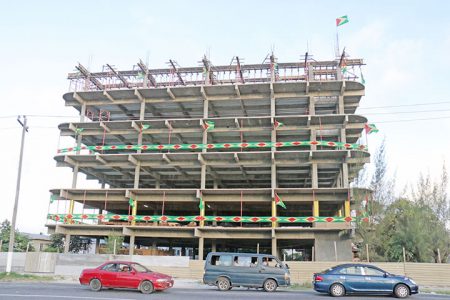 Mash Ready! This unfinished building on Vlissengen Road and Sandy Babb Street was well decorated with Guyana flags yesterday. (Photo by Arian Browne)