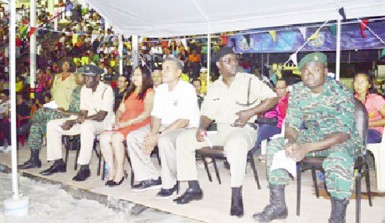 Minister of Amerindian Affairs Pauline Sukhai (fourth from right) and Region Seven Chairman Gordon Bradford (third from right) at the Republic Anniversary flag raising ceremony in the region. (GINA photo) 