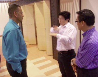 Minister of Natural Resources and the Environment, Robert Persaud (left), in discussion with Malaysian officials. (GINA photo) 