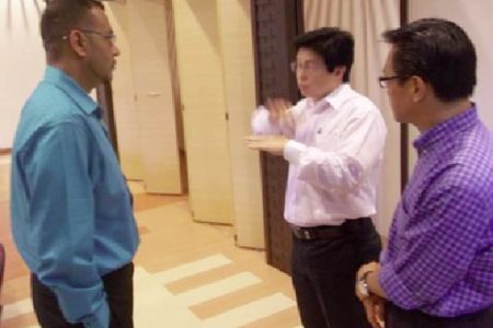 Minister of Natural Resources and the Environment, Robert Persaud (left), in discussion with Malaysian officials. (GINA photo)