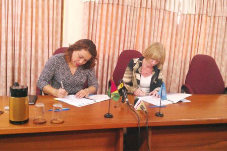 Foreign Affairs Minister Carolyn Rodrigues-Birkett (left) and UNICEF’s Resident Representative Marianne Flach sign the Government of Guyana – UNICEF Annual Work Plan.