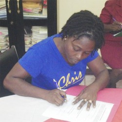  Shaunette Shipley of Linseed signing the contractual agreement in order to receive the donation.