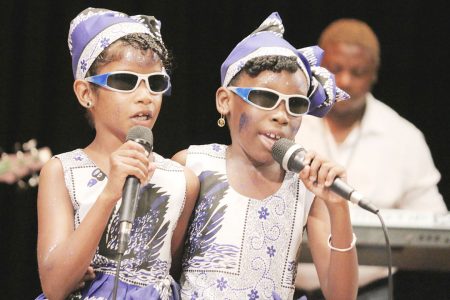 Mekyla Belgrave and Angelica Bassoo of the Resource Unit for the Blind and Visually Impaired performing `I can’ in the calypso segment of the children’s Mashramani contest finals yesterday at the National Cultural Centre.