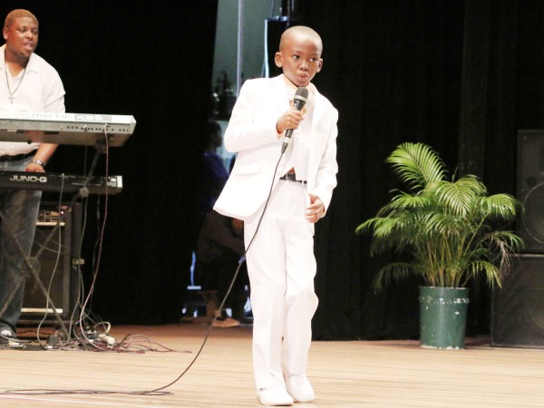 A dapper Ofori Archer of the Latchmansingh Primary performing `A warning to students’ in the calypso category of the children’s Mash contest at the National Cultural Centre yesterday. 