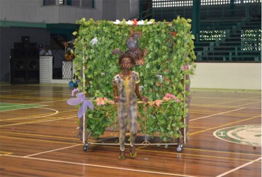 A student of Tucville Primary displaying her piece at the Cliff Anderson Sports Hall on Thursday. (GINA photo)