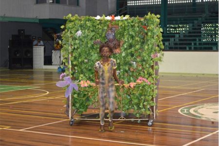A student of Tucville Primary displaying her piece at the Cliff Anderson Sports Hall on Thursday. (GINA photo)