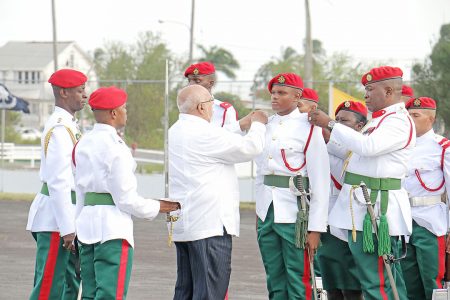 President Donald Ramotar (third from left) and Chief of Staff of the Guyana Defence Force Brigadier Mark Phillips today decorating the Best Graduating Student, Ensign Simon Gordon with badges. Gordon was the Best Student of Standard Officers’ Course #46.